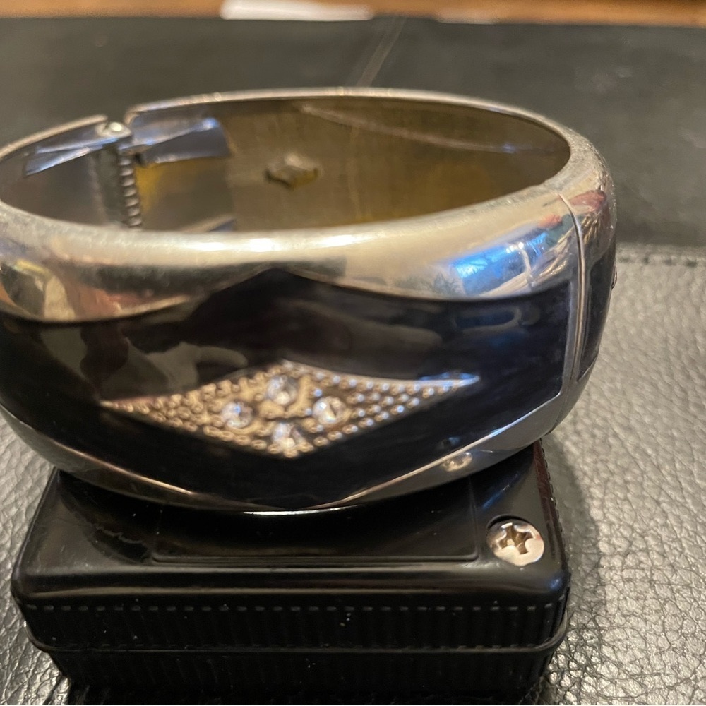 Silver, black enamel, rhinestones bracelet. Bracelet is hinged. No dents, scrape